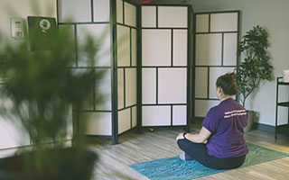 Staff member meditating in the Wellness Centre