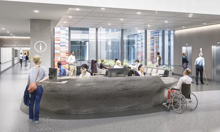 An artist rendering of a welcome desk inside the main entrance of a new hospital. Hospital staff are seated behind the wide grey desk. A visitor stands in front of the desk on the left, while a visitor in a wheelchair is in front of the desk on the right. A hallway on the left leads to the background, and elevators are in the background on the right. Behind the desk, there are large windows with colourful artwork at the left and right of them and people seated in a waiting area.