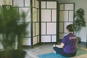Staff member meditating in the Wellness Centre