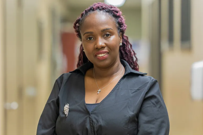 Kaywana Malcolm standing in the hallway of the OnTrack program’s office.