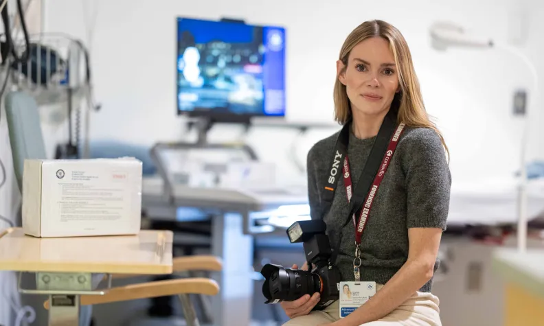 Lynn Bates, Advanced Practice Nurse, Sexual Assault and Partner Abuse Care Program, holds a camera in the SAPACP clinic.