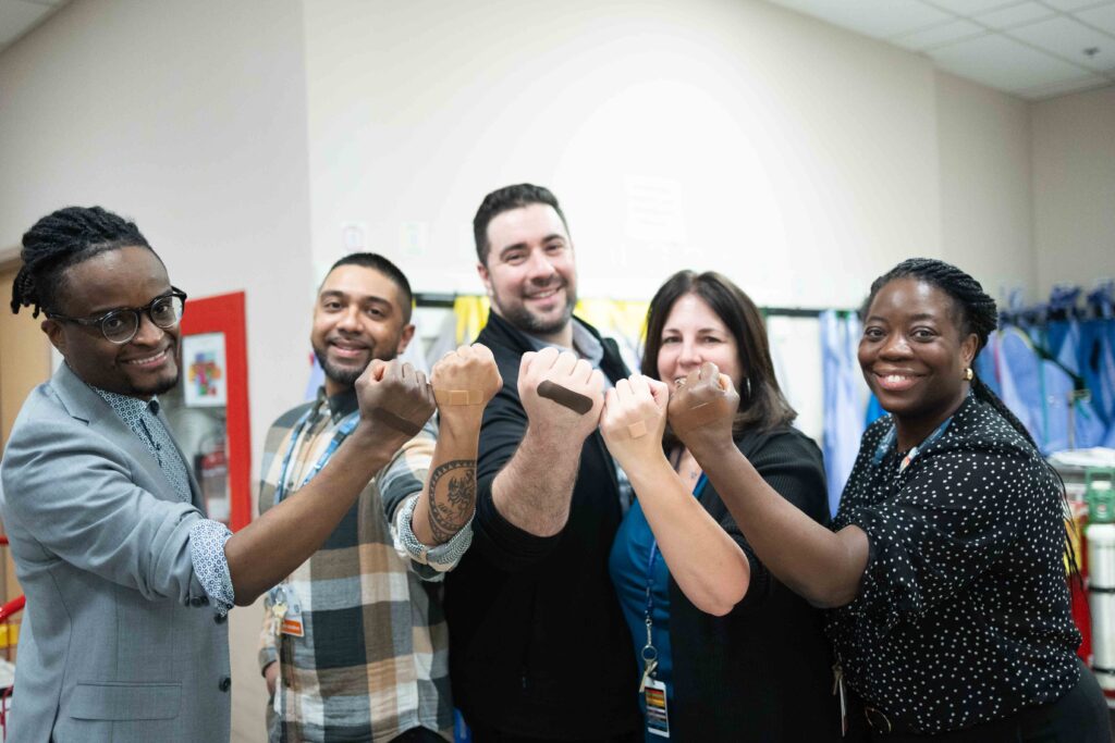 Ellen Odai Alie and her colleagues wear the new inclusive bandages.